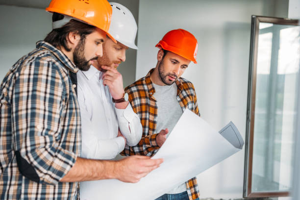 istock group of architects with blueprint inside of constructing building 1011404072