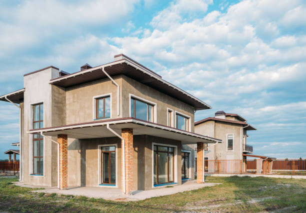 istock unfinished modern concrete buildings with green yards under cloudy sky 1011404382