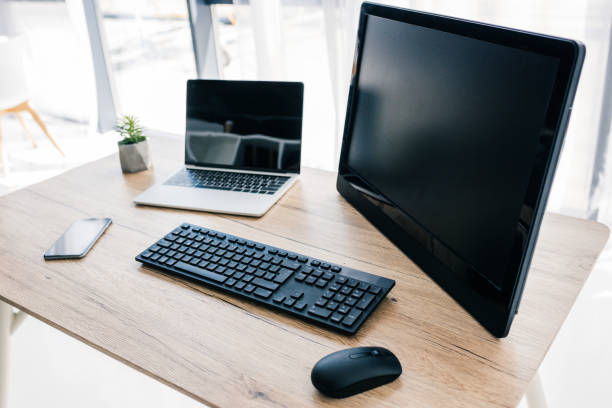 istock closeup view of computer, laptop, smartphone and potted plant on table 1011411366