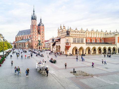 Market square with horse-drawn cab in heart of Krakow old town, Poland