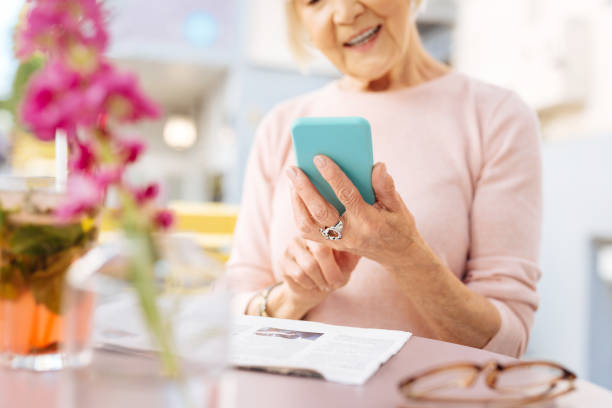 istock Mature female hands using phone 1011414726