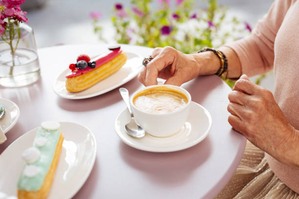 istock Mature female hands seizing coffee 1011416390
