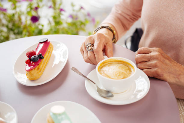 istock Senior female hands gripping coffee 1011416416