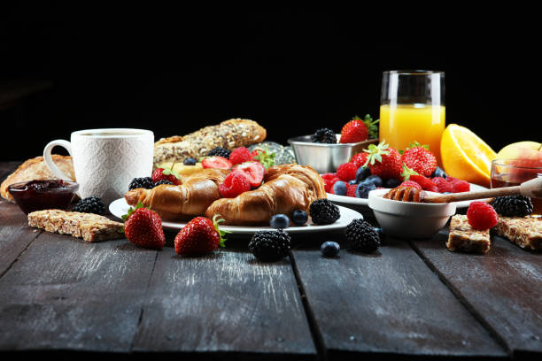 Copy space on white picnic blanket with various fruits, pastries, berries and juice. Watermelon, melon or cantaloupe, red cherries, blackberries, lemon and peach on plaid in park, top view