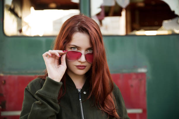 Young  woman wearing bomber jacket and sunglasses