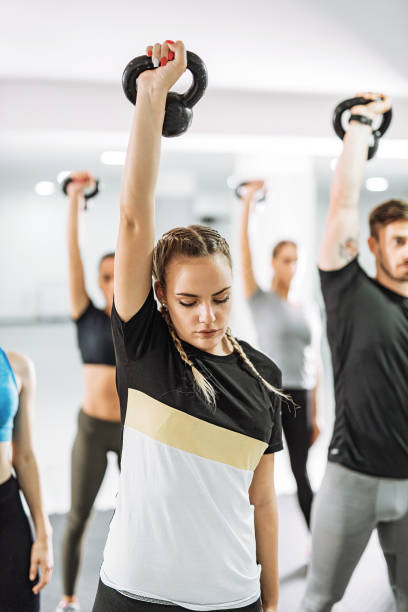 istock Female instructor on fitness class with kettlebells 1011419708
