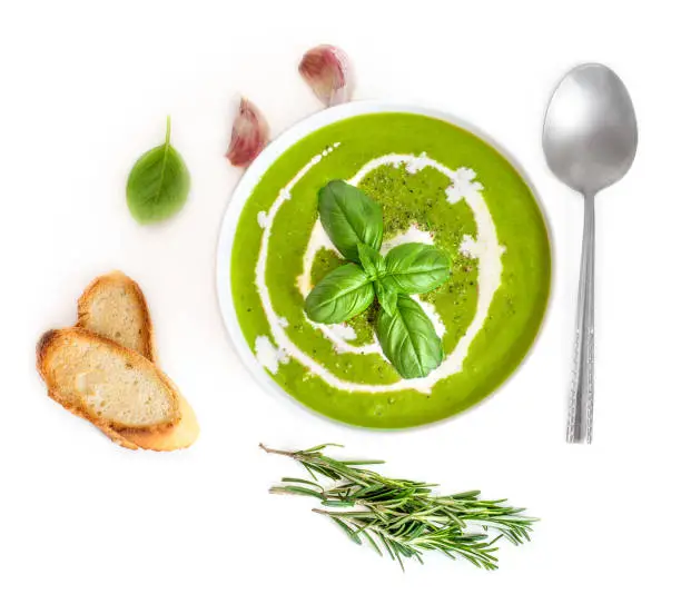 Bowl of Broccoli and Spinach  cream soup with coconut cream  isolated on white background.  Top view