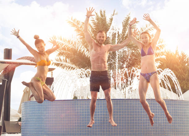 istock Jumping to swimming pool in luxury hotel 1011422634