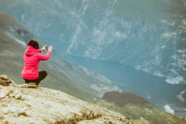 istock Tourist taking photo from Dalsnibba viewpoint Norway 1011428620