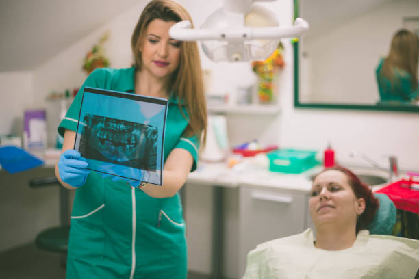 istock Dentist and female patient looking to x-ray 1011433324
