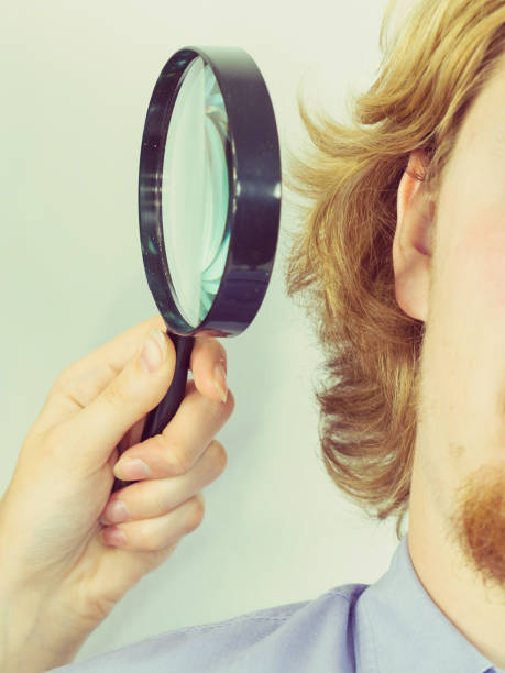 istock Man with magnifying glass close to ear 1011433772