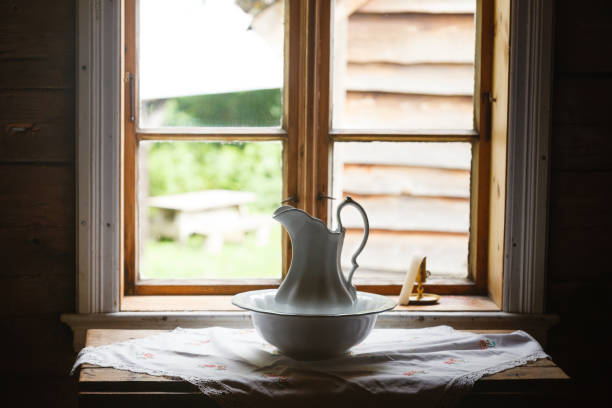 istock Old vintage window, ceramic jug in foreground 1011437938