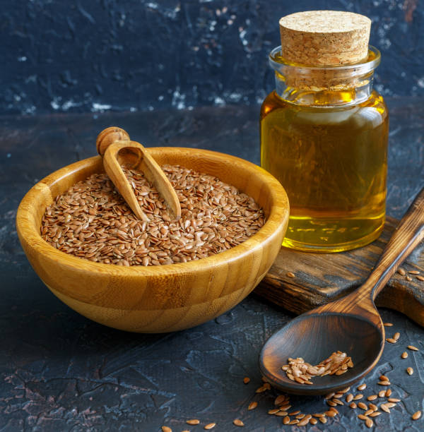 istock Linseed oil and flax seeds in a bow. 1011438474