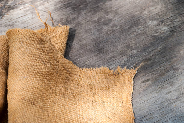 burlap hessian sacking on wooden background.