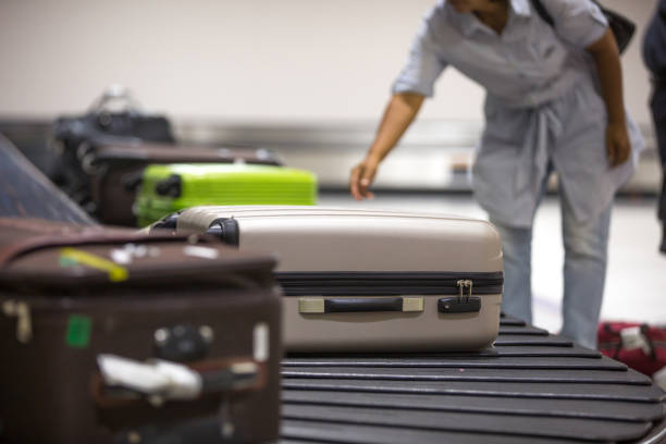 istock Wheeled suitcases on transfer belt at the airport. 1011441248