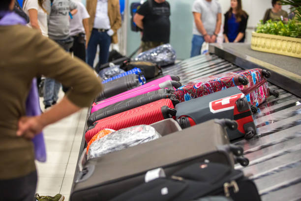 istock Wheeled suitcases on transfer belt at the airport. 1011441320