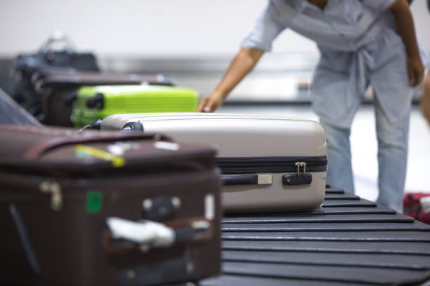 istock Wheeled suitcases on transfer belt at the airport. 1011441492