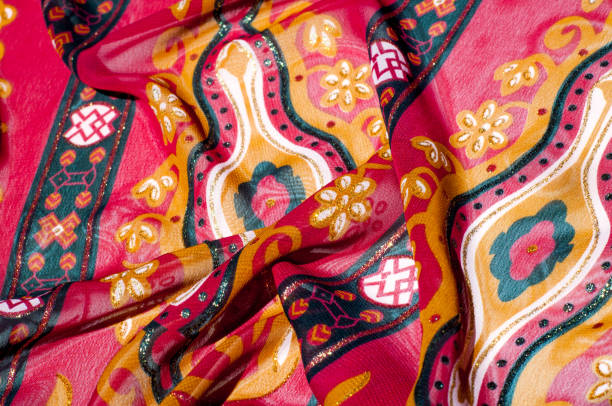 istock Background texture, pattern. Red maroon fabric. Click on your local heritage with this red, bard and yellow striped silk. This patterned fabric will decorate your design. your work will be exclusive 1011448390