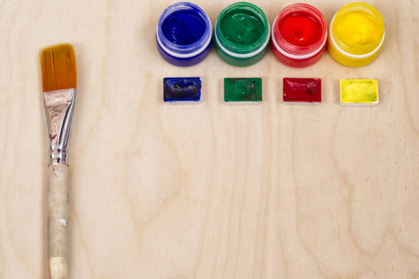 istock Paint bottles and artistic brush. 1011451394