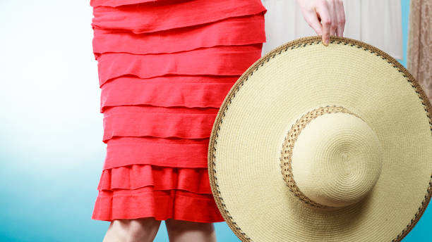istock Woman holding sun hat 1011454800