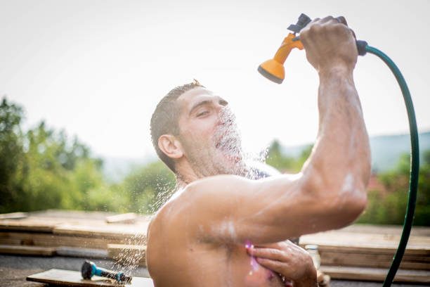 Sportsman is splashing his face with water after training