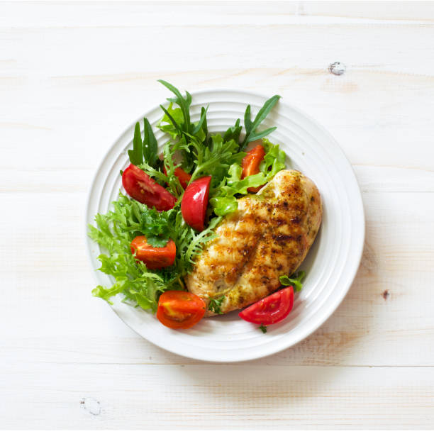istock Grilled chicken fillet  and fresh vegetable salad 1011467394