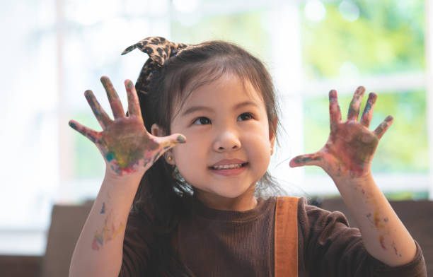 istock Asian kids with dirty painted hand in art classroom 1011473732