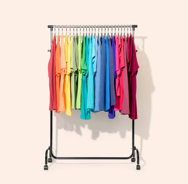 istock Mobile rack with color clothes on light background 1011477056
