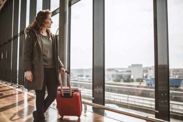 istock Woman with suitcase is going to board 1011502596