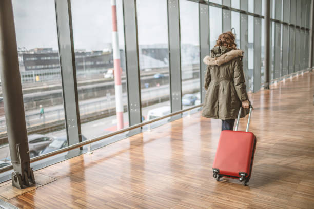 istock Woman with suitcase is going to board 1011505020