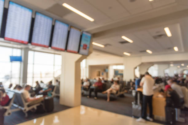 istock Abstract passenger at airport terminal waiting area with flight Information screens 1011506420