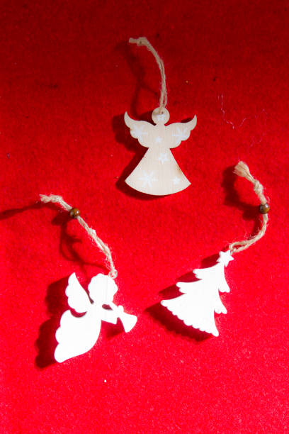 istock WHITE WOOD CHRISTMAS ORNAMENTS ON RED BACKGROUND 1011529496