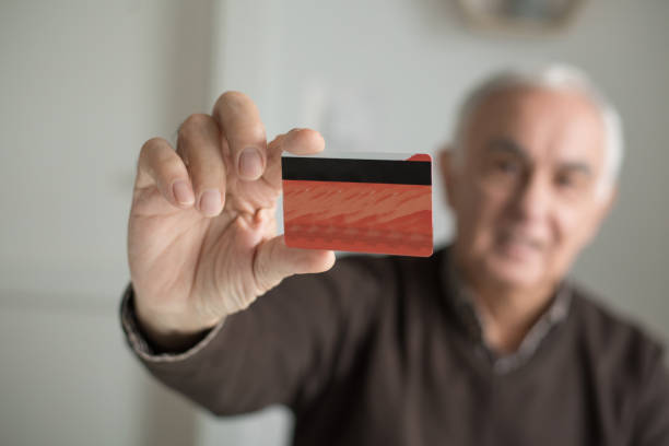 istock Elderly man with credit card 1011533772