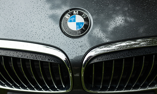 Crozon, France - May 29th, 2018: Bmw motor company badge on the front from a black car. BMW is a German automobile, motorcycle and engine manufacturing company founded in 1916.