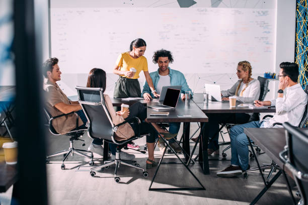 istock multiethnic business partners having meeting at table with laptops in modern office 1011542246
