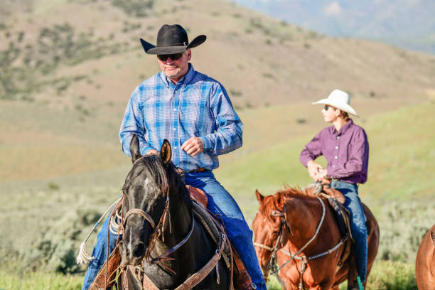 istock Father and Son Horseback Riding Outdoors in Spring Utah USA 1011547270