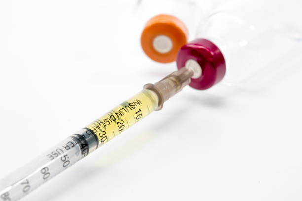 White square stand with test tubes, ampoule with medicine and syringe on a blue background. Medical devices. Preparing for vaccination