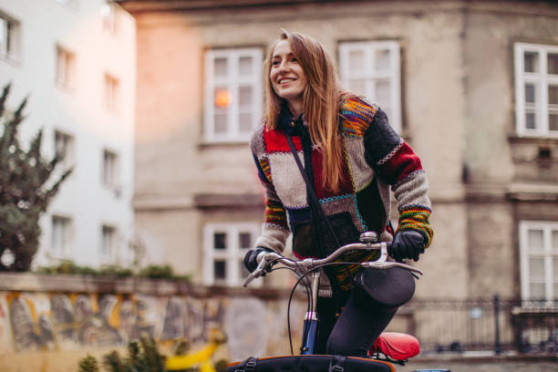 Cargo bike ride Smiling young woman riding a cargo bike in the city cargo bike photos stock pictures, royalty-free photos & images
