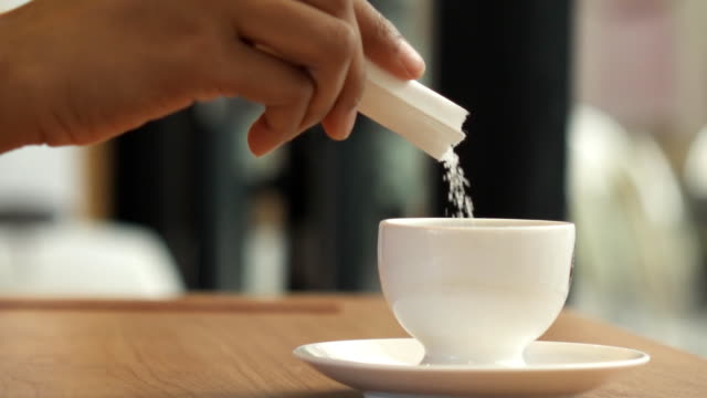 HD Super Slow motion Sugar Pouring in to Coffee