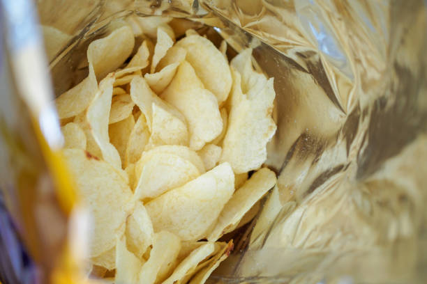 istock Potato chips in open snack bag close up 1011590354