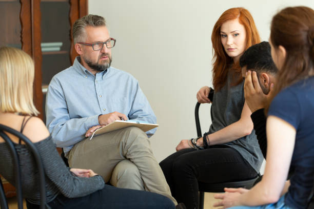 istock Counselor talking to his patients on a group therapy 1011590438