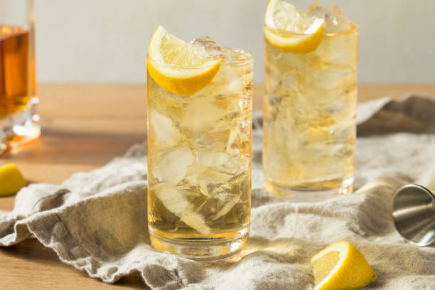 Homemade Seven and Seven Whiskey HIghball Homemade Seven and Seven Whiskey HIghball with Lemon glass of bourbon stock pictures, royalty-free photos & images