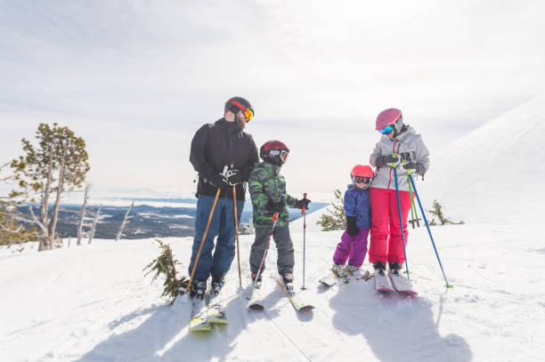 istock Two young kids snow skiing with their parents 1011611214