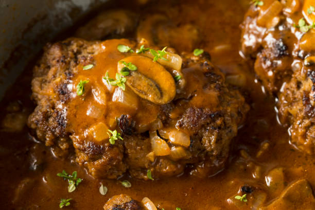 Homemade Savory Salisbury Steaks Homemade Savory Salisbury Steaks with Peas and Mashed Potatoes salisbury steak stock pictures, royalty-free photos & images