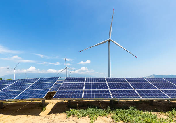 istock solar panel and wind turbine on sandy land with blue sky 1011626364
