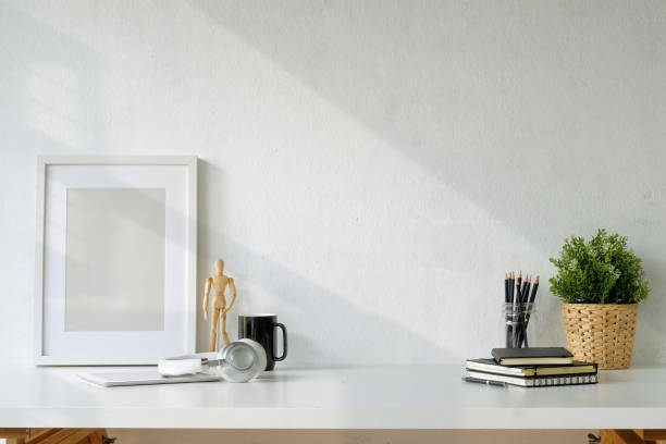 istock Poster with supplies on white desk. workspace and copy space. 1011626390