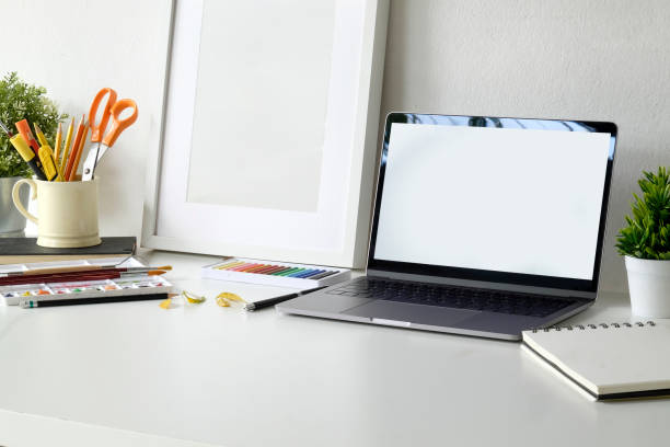 istock Creative workspace with blank screen laptop and artist craft tools on desk. 1011626648