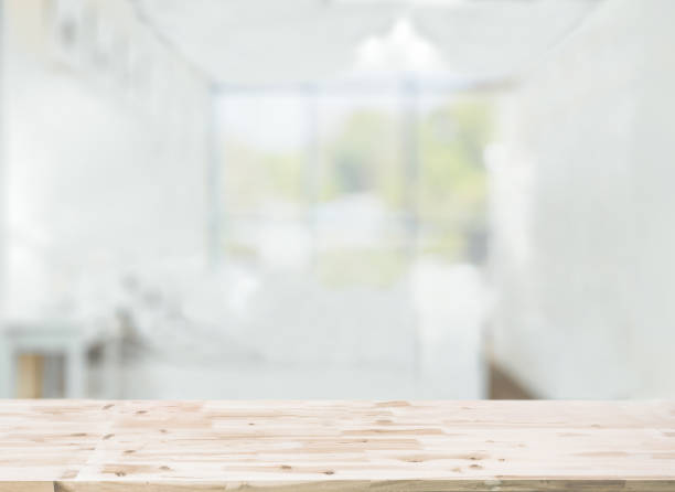 Wooden table top in front of blurred bedroom interior background stock photo