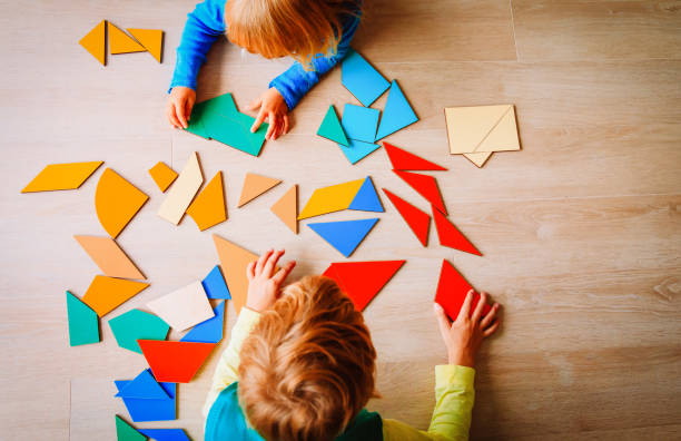 istock kids playing with puzzle, education concept 1011642552