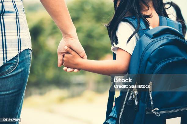 Cute Asian Pupil Girl With Backpack Holding Her Mother Hand And Going To School Stock Photo - Download Image Now